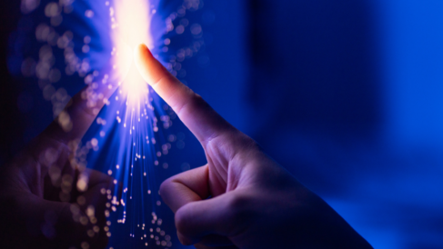 A human hand touching a digital screen.