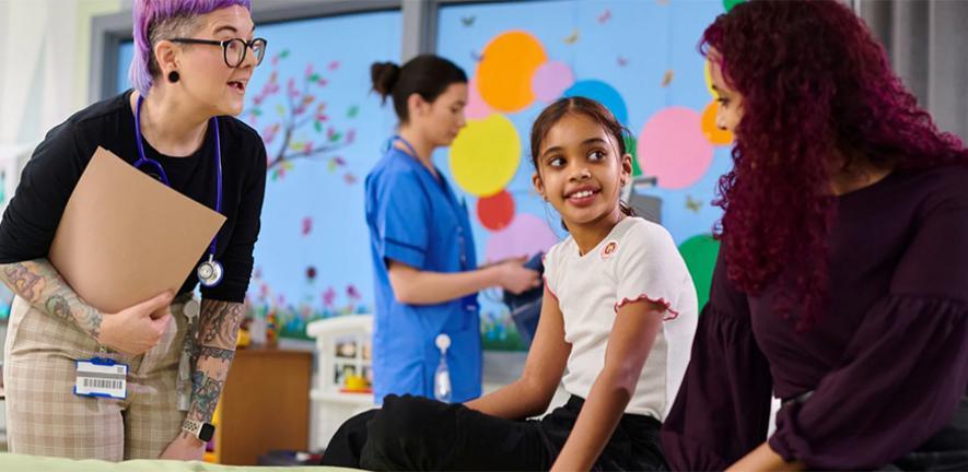 A child and their carers in a children's hospital ward.