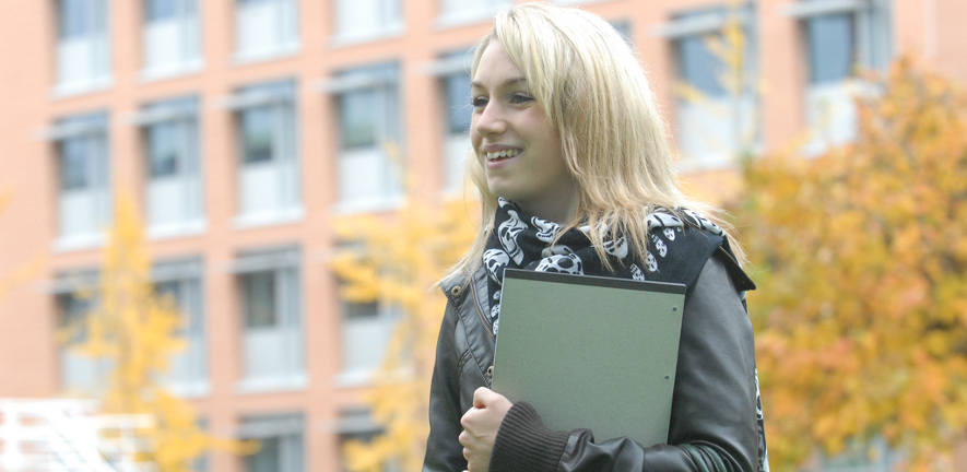 girl smiling with folder